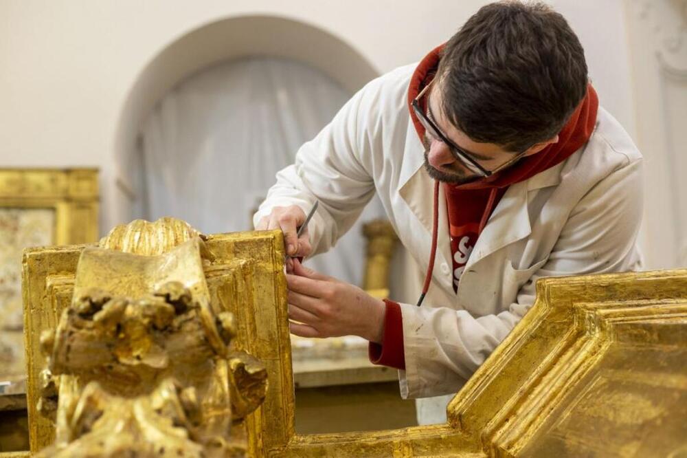 Álvaro Sarmiento trabaja en la restauración de un retablo barroco en Almonacid.